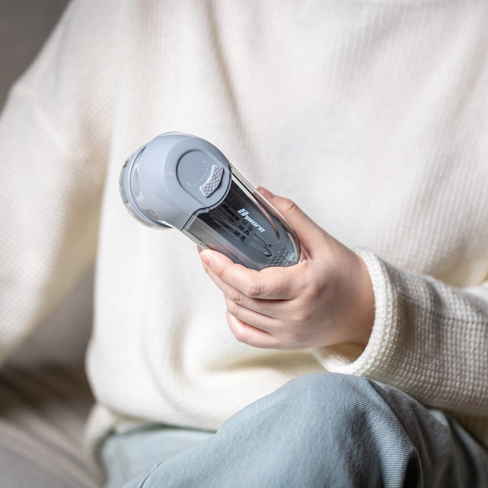 Holding a Bymore fabric shaver